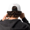 A person with their hands on the back of his head