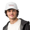 A man wearing a white hat with the word " oakland " on it.
