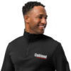 A man wearing a black jacket with oakland on it.