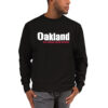 A man wearing a black sweatshirt with oakland and other words in white.